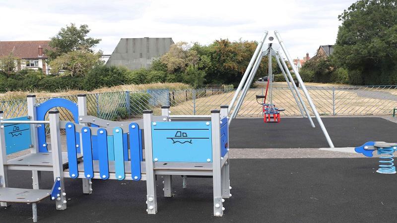 Picture of play area, including climbing frame and swing for toddlers.