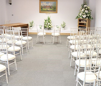 The Bromley Civic Centre Ceremony Room with flowers and ornate chairs.