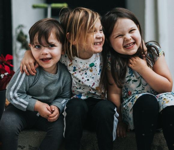 Three children smiling