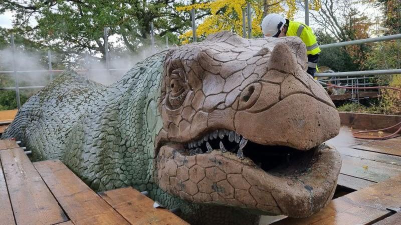 Crystal Palace Park dinosaur model being carefully steam cleaned.