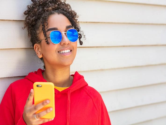 Young person holding mobile phone