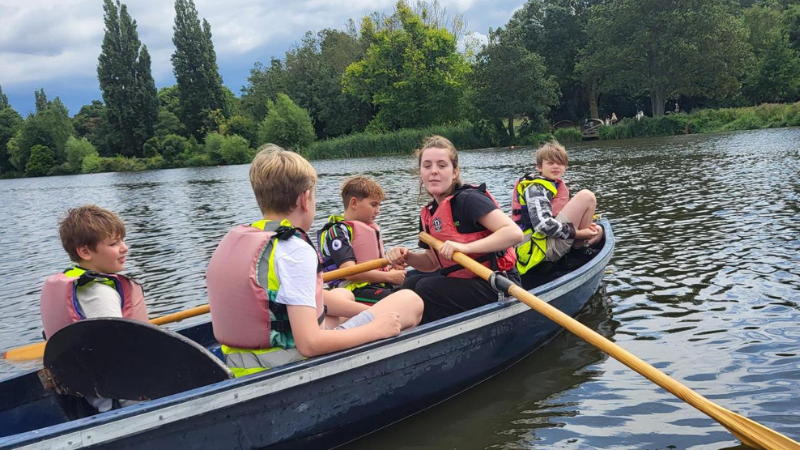 CASPA Danson Park: Photo of four children and an instructor rowing a boat on a lake.