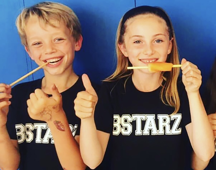 BStarz Drama Camp - Saint Philomenas Primary: Photo of two children with BStarz branded shirts on while holding ice lollies.
