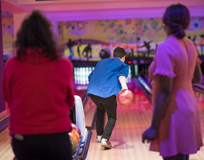 CASPA - Bowling Turpington Activity Centre: Photo of three young people playing bowling at a bowling alley.