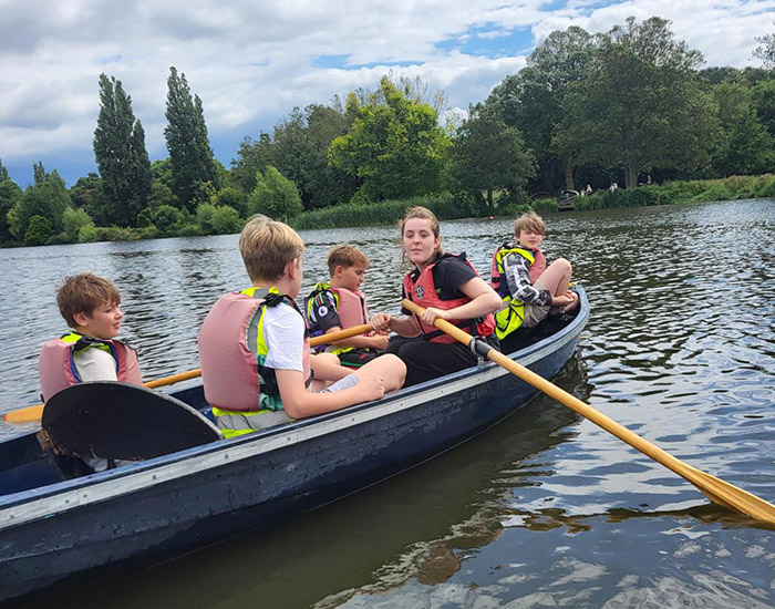 CASPA Danson Park: Photo of 4 children and an instructor rowing a boat on a lake.