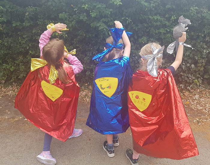 Frutie Tutie Kidz Club - Perry Hall Primary: Photo of three children outside wearing homemade superhero costumes.