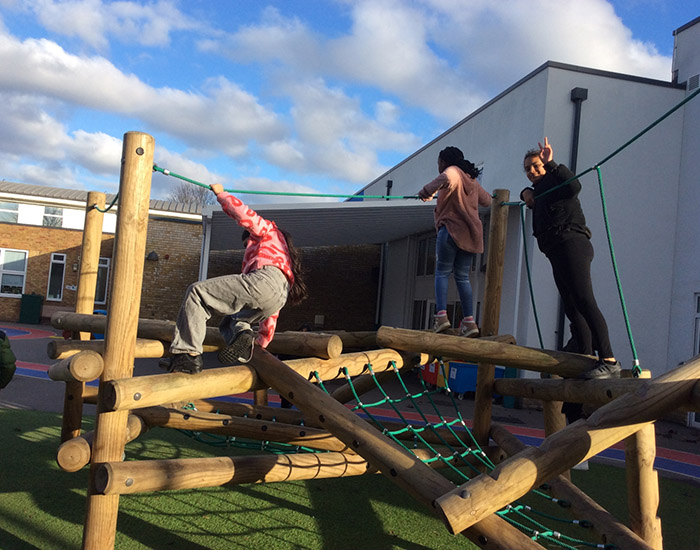 Omega Sportz - Leesons Primary: Photo of two children and an instructor playing on a climbing frame.