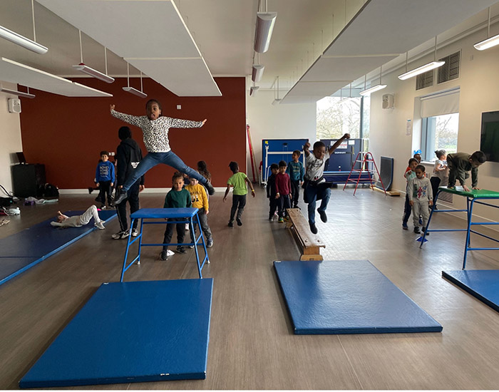 Omega Sportz - Ravensworth Primary: Photo of a group of children playing on climbing and gymnastics tools.