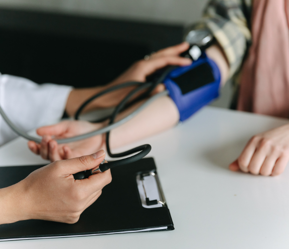 Image shows someone having their blood pressure checked.