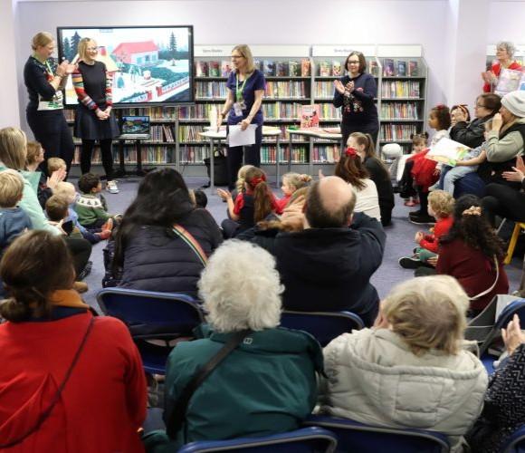 Crowd gathered watching children’s book reading sessions.