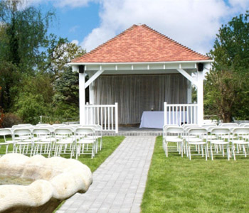 Oakley House's gazebo decorated with ceremony chairs on the lawn.