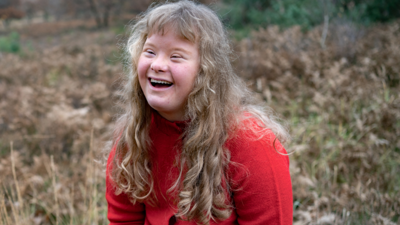 Photo of a young woman outside with special educational needs and disabilities (SEND).