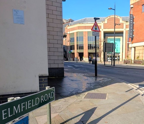 Image shows a photo of Elmfield Road and its road sign.