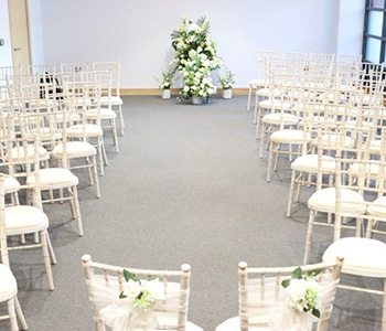 The Ceremony Room displaying a spray of artificial flowers.