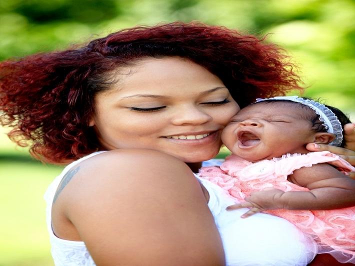Person holding yawning baby