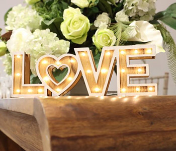 The word love illuminated in fairy lights.